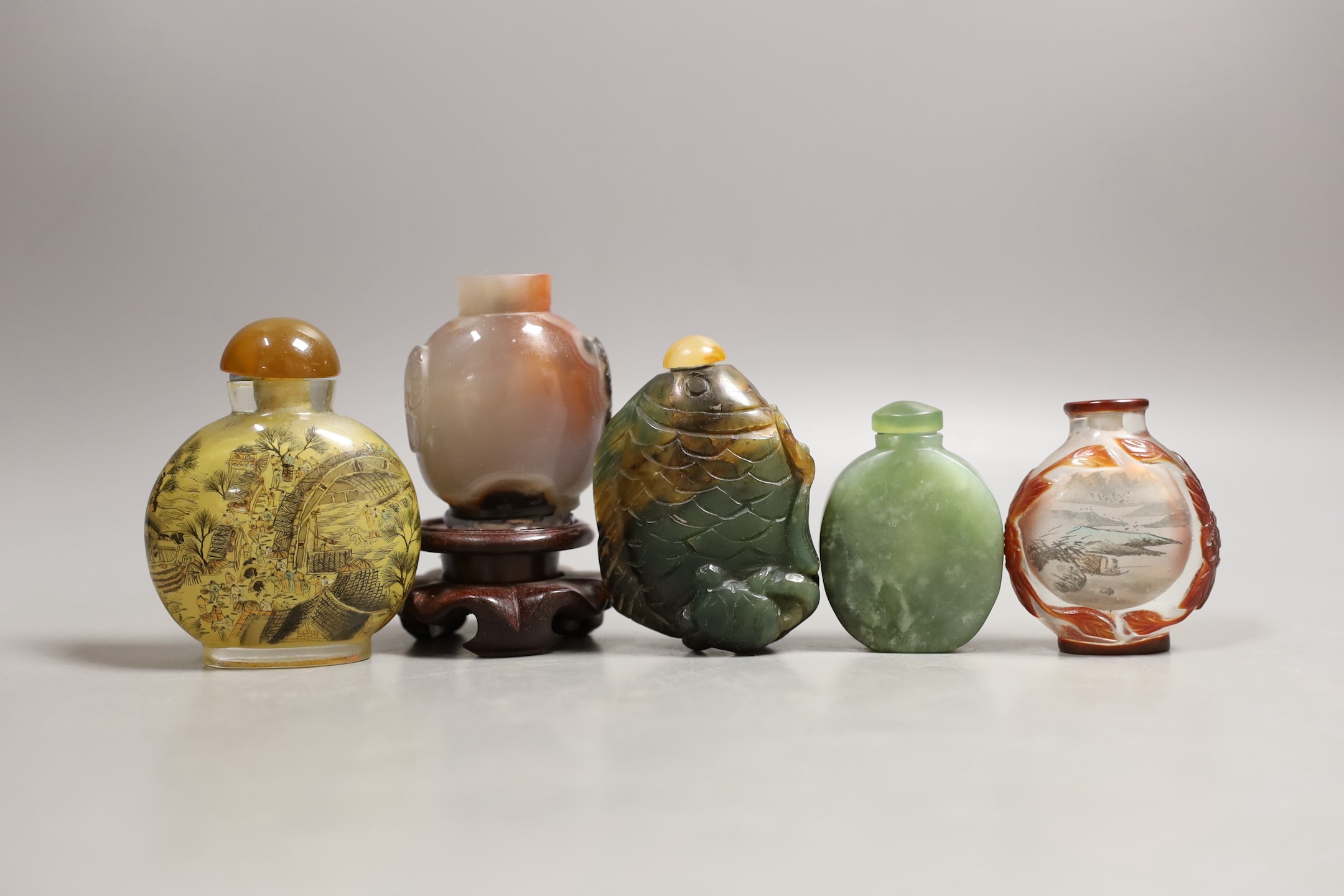 Five Chinese jade, glass and hardstone snuff bottles, the largest 7cm